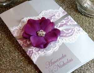 A close up of a Quinceanera invitation card with a flower on it