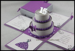 A Quinceanera cake, a purple and white cake decorated with sugar and a candle on top