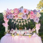 Flower decoration for a Quinceanera celebration. A table topped with a pink tutu skirt and flowers.