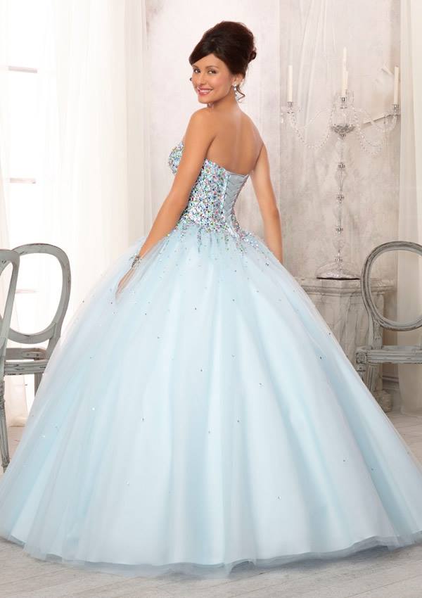 A woman wearing a light blue Quinceanera ball gown