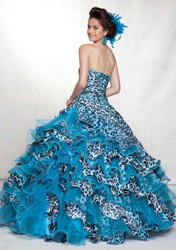 A woman wearing a blue and black leopard print Quinceañera dress