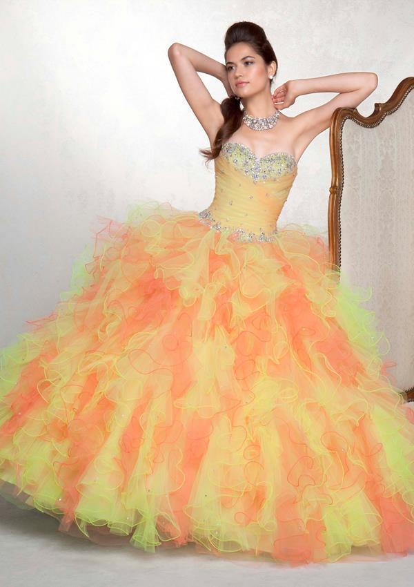 Quinceanera gown, a woman in a yellow and orange dress posing for a picture