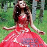 A woman in a red dress standing in a field wearing a Quinceanera gown