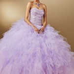 Quinceañera dresses, a woman in a purple ruffle dress posing for a picture