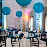 Quinceanera celebration with a room filled with lots of tables covered in blue balloons