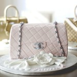 A pink Quinceanera handbag cake, sitting on top of a white plate