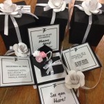 Quinceanera invitation, a group of black and white boxes with white ribbons adorned with the Chanel logo