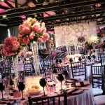 Chanel Quinceanera theme ideas - A room with tables for a Quinceañera celebration