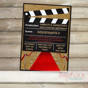 A Quinceanera invitation, featuring a movie clapper board on a table
