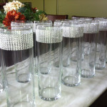 Quinceanera wine glass table, a long table with a bunch of glasses on it.