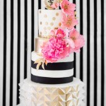 Quinceanera cake, a three tiered cake with pink flowers on top
