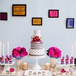A table with a Quinceanera cake and cupcake, decorated with intricate frosting designs