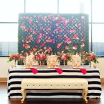A black and white table topped with flowers, perfect for Quinceanera celebration