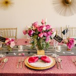 Floral design with cut flowers on a table set for a formal Quinceanera dinner with pink flowers