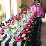 Quinceanera black and white striped party decor Table, with pink napkins and place settings