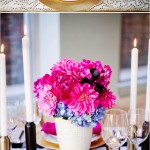 A beautiful Quinceanera table setting with cut flowers, candles, and floral design.