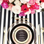 Quinceanera, a black and white striped table setting with pink and white flowers in a Kate Spade color palette
