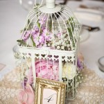Quinceanera, a birdcage centerpiece idea with flowers and a picture frame
