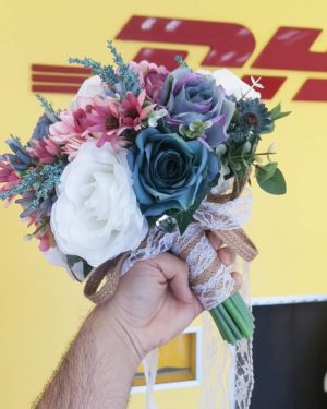 A man holding a bouquet of flowers in front of a DHL truck with a floral design