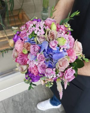 Floral design with a man in a suit holding a bouquet of flowers at a Quinceanera