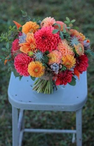 a Quinceanera bouquet of flowers sitting on top of a chair