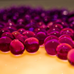 Close up of a Quinceanera centerpiece featuring a bunch of red balls on a table