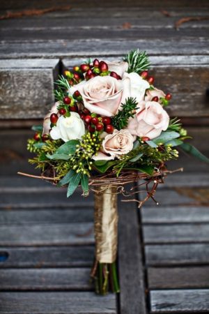 A Quinceanera bouquet of flowers sitting on top of a wooden bench during Christmas
