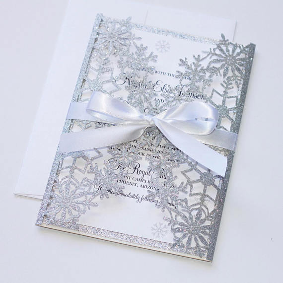 Close up of a Quinceanera invitation card with a ribbon, winter theme