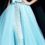 A woman in a blue Quinceanera gown posing for a picture