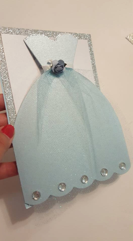 Quinceanera: A person cutting a piece of paper with a pair of scissors