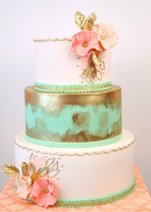 Quinceanera image featuring coral and green color scheme with a wedding invitation and a three-tiered cake adorned with pink flowers on top