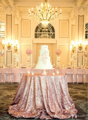 Quinceanera function hall table with a wedding cake sitting on top of it.