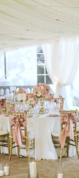 Dusty rose gold Quinceanera decor, a table set up for a Quinceanera party