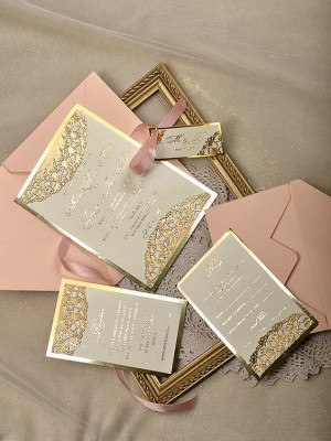 Quinceanera invitations in gold color, a collection of cards and envelopes arranged neatly on a table