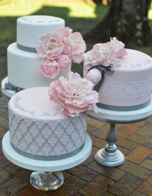 Quinceanera cake, a three-tiered cake with pink flowers on top