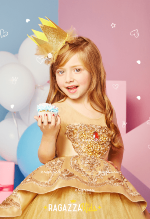 Quinceanera: A beautiful dress with a little girl holding a cupcake