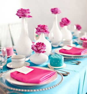 A Quinceanera themed pink and blue tablescape with pink and blue place settings.