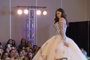 Quinceanera gown, a woman in a quinceanera dress walking down a runway