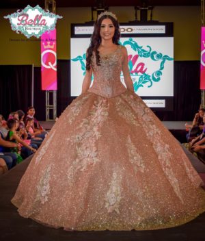 A Quinceanera gown - a woman in a dress walking down a runway