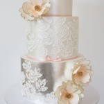 A three-tiered Quinceanera cake with flowers on top