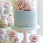A table topped with cupcakes and cakes covered in frosting, reminiscent of vintage Quinceanera celebrations.