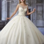 A woman in a Quinceanera gown posing for a picture in a Cinderella style Quinceanera Dress