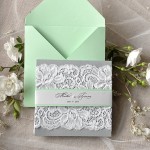A mint green rustic Quinceanera invitation on a table
