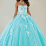 Teal and white Quinceañera dresses, a woman in a blue dress posing for a picture
