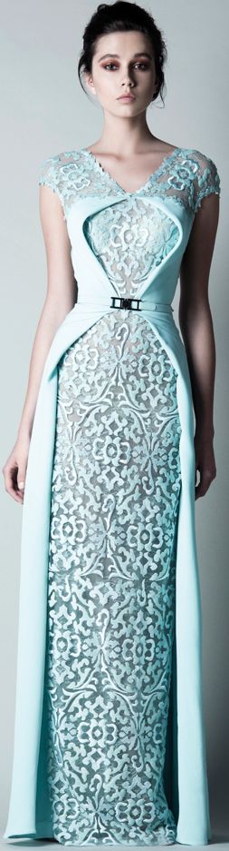 A fashion model wearing a blue Quinceanera dress and a white Quinceanera dress