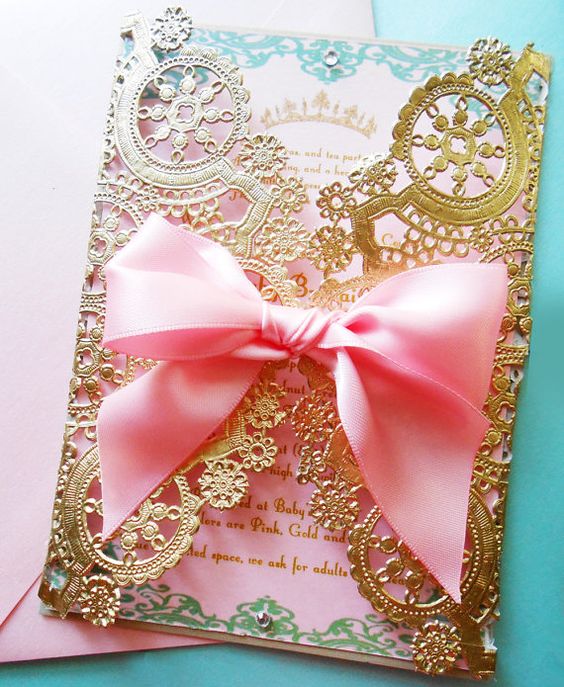 A Quinceanera Invitation, a pink and gold Quinceanera card with a pink bow