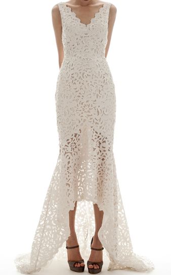 A woman in a white Quinceanera gown posing for a picture