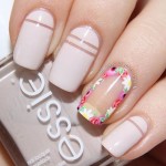 A person with a manicured Quinceanera nail holding a bottle of nail polish