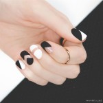Quinceanera inspired nail art design, featuring a black and white manicure on a woman's hand