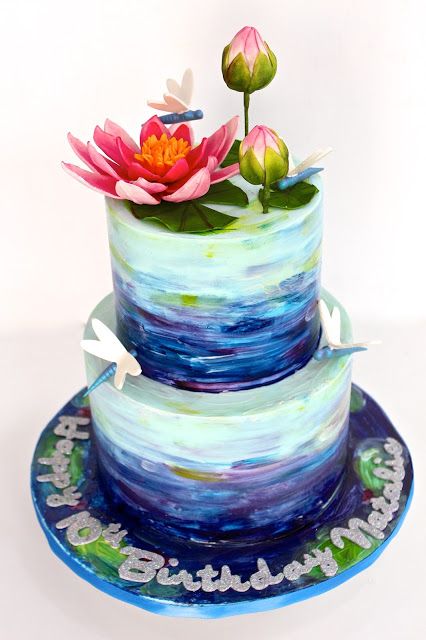 A Quinceanera themed cake featuring a three-tiered design. The cake is decorated with beautiful flowers on top, resembling a lotus design.